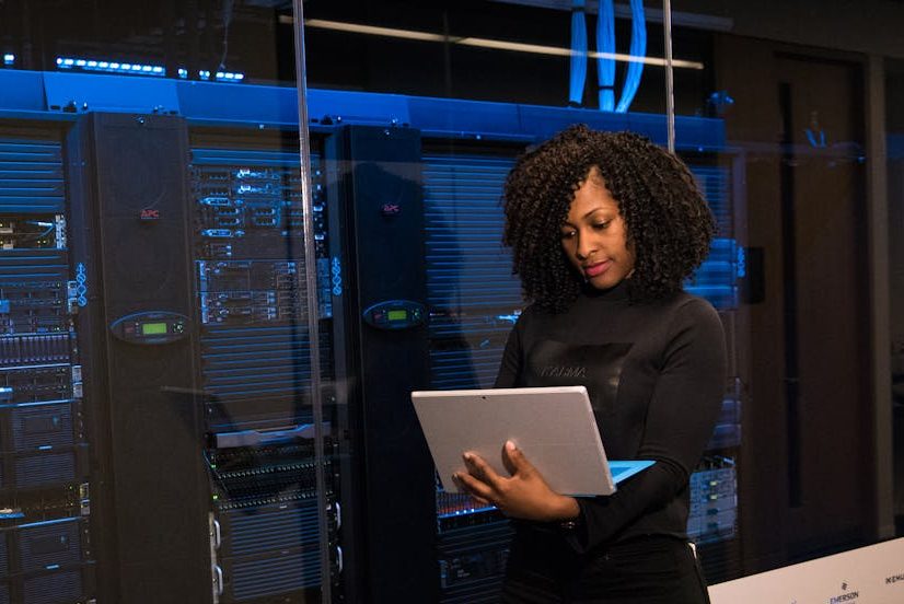 Software Engineer Standing Beside Server Racks